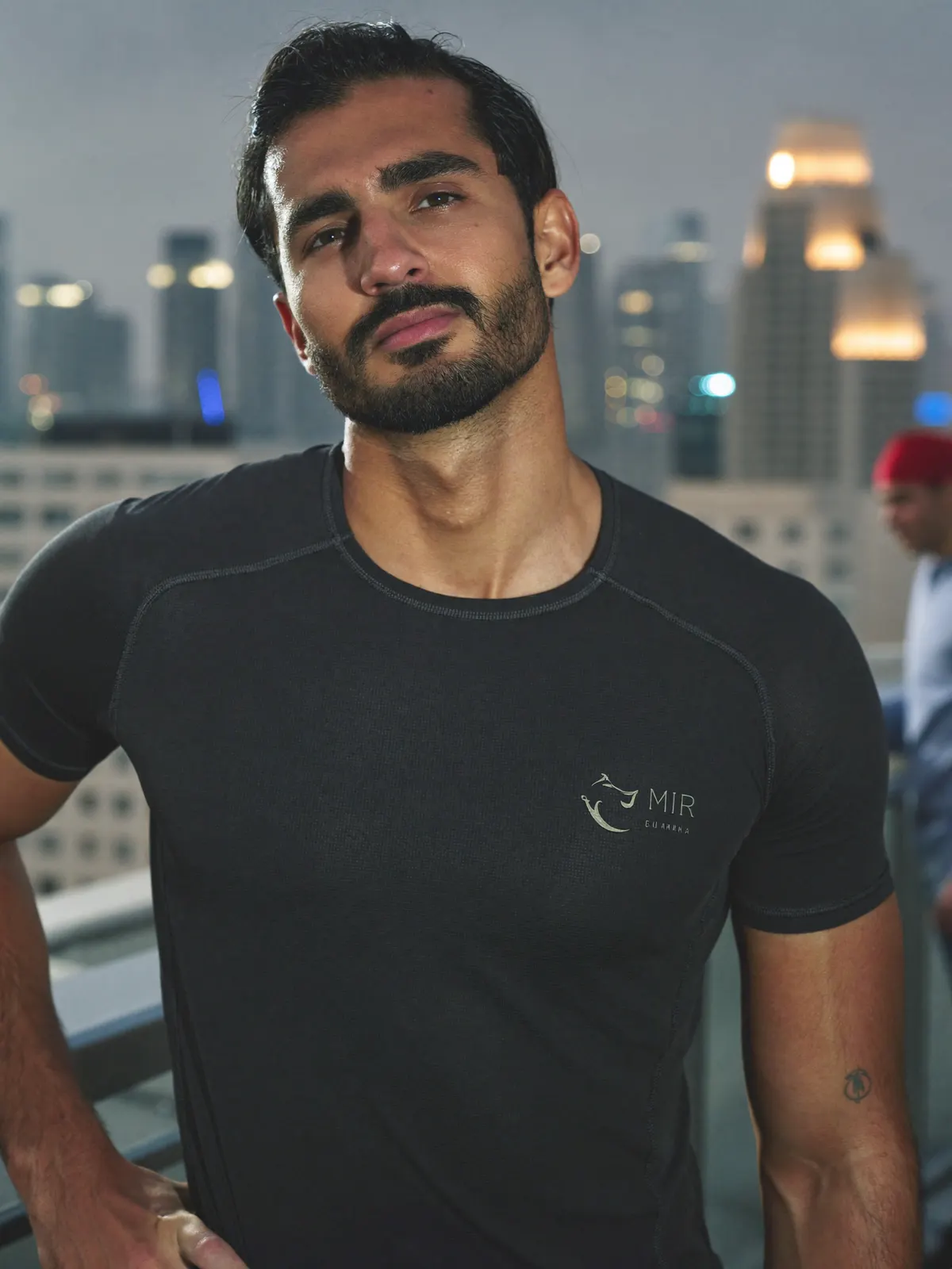 Portrait of a HIIT and strength coach on a rooftop at dusk