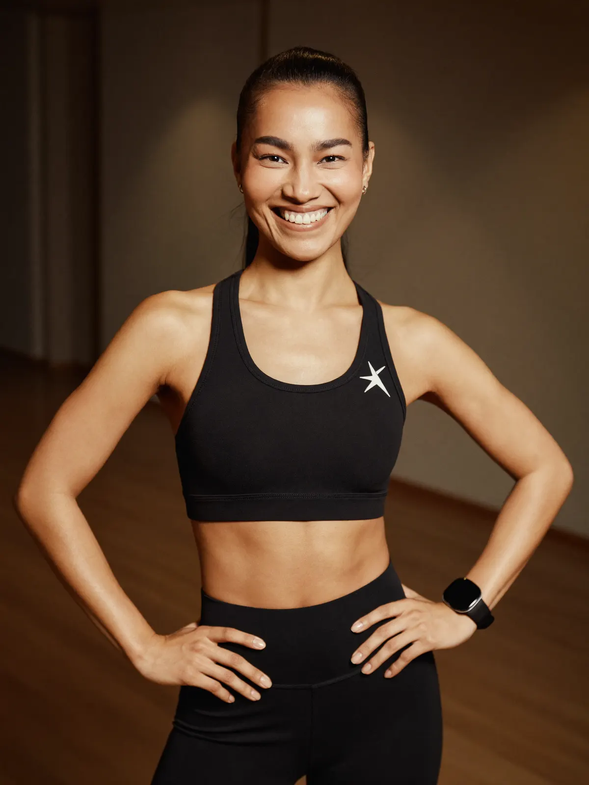 Portrait of a dance and conditioning coach in a warm-lit studio