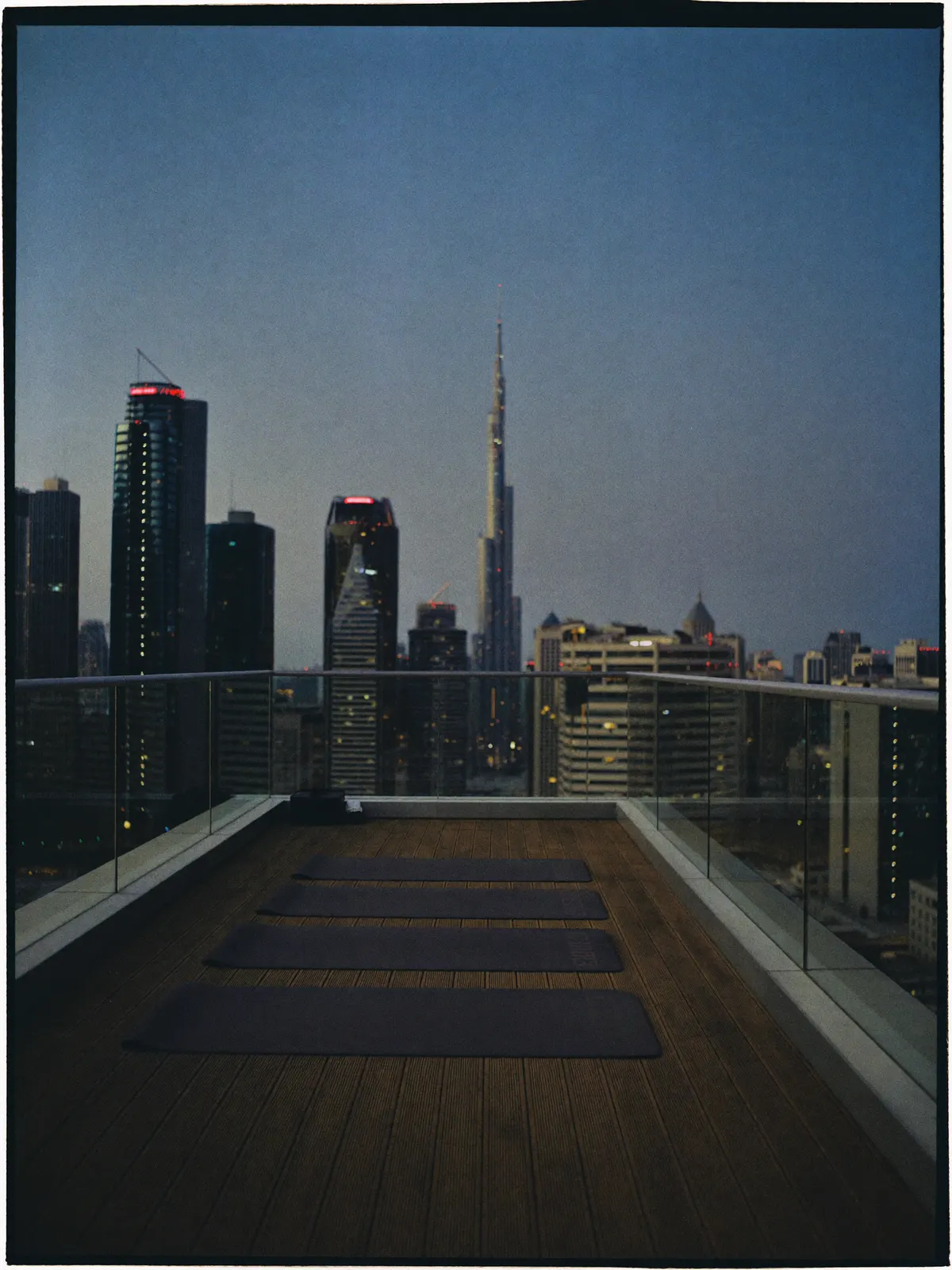 A rooftop terrace at dusk prepared for a fitness class