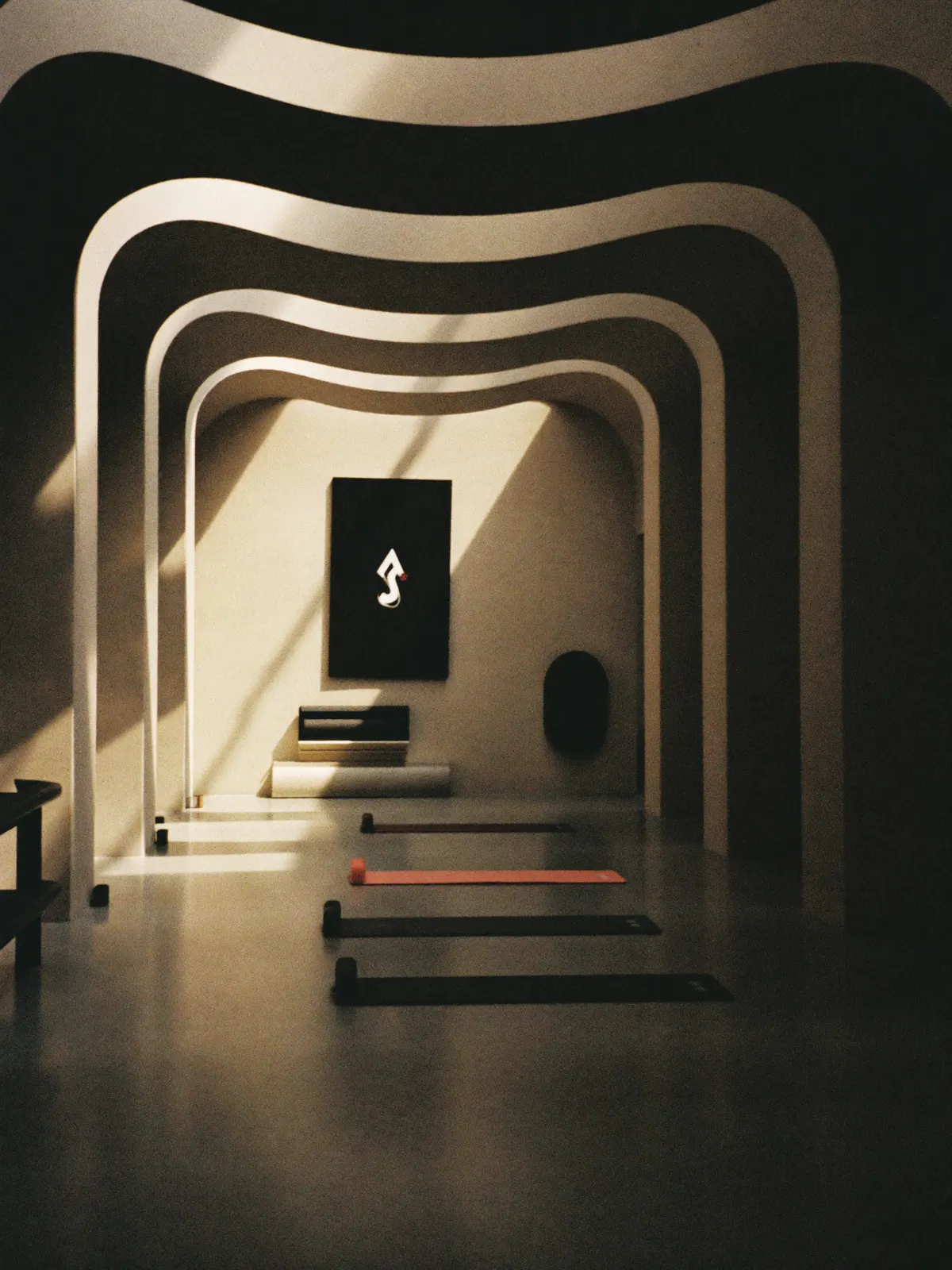 A dramatic contemporary art space atrium with mats on the polished floor